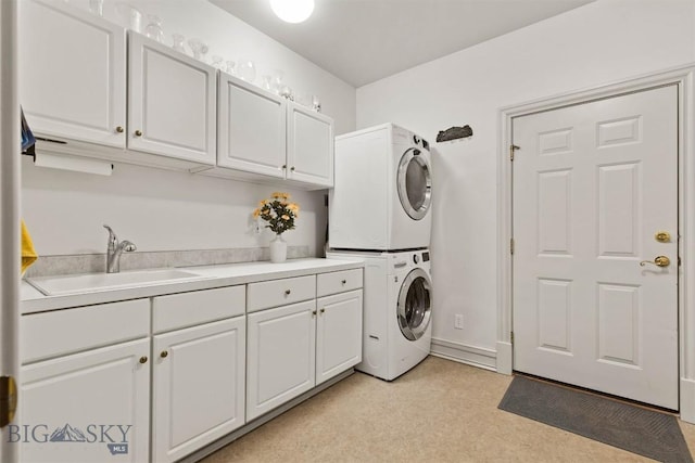 10423 Bridger Canyon Rd, Bozeman, MT 59715 - laundry area featuring estacked washer and dryer and cabinet space