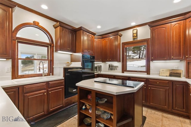 10423 Bridger Canyon Rd, Bozeman, MT 59715 - kitchen with oven, light countertops, recessed lighting, ornamental molding, and a kitchen island