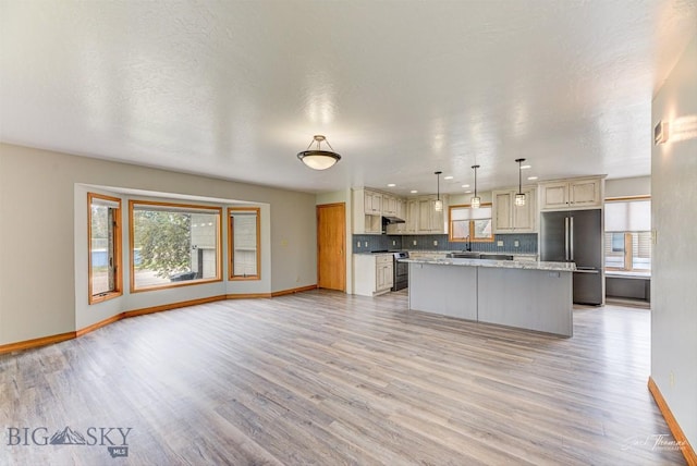 620 Higgins, Deer Lodge, MT 59722 - kitchen featuring appliances with stainless steel finishes, healthy amount of natural light, light wood-style floors, and a kitchen island