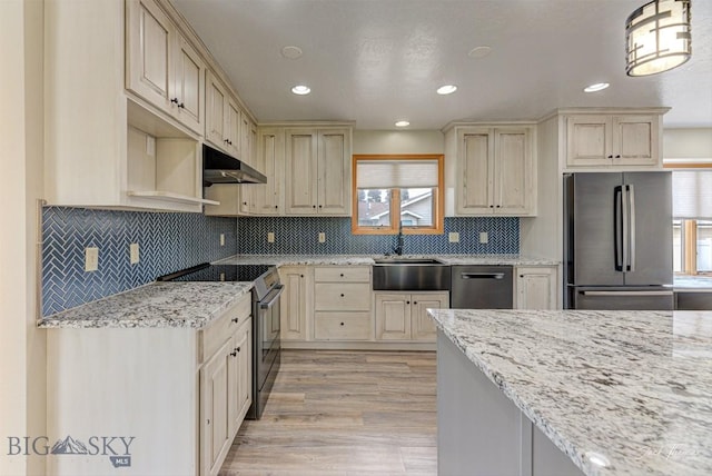 620 Higgins, Deer Lodge, MT 59722 - kitchen featuring stainless steel appliances, plenty of natural light, under cabinet range hood, light stone countertops, and recessed lighting