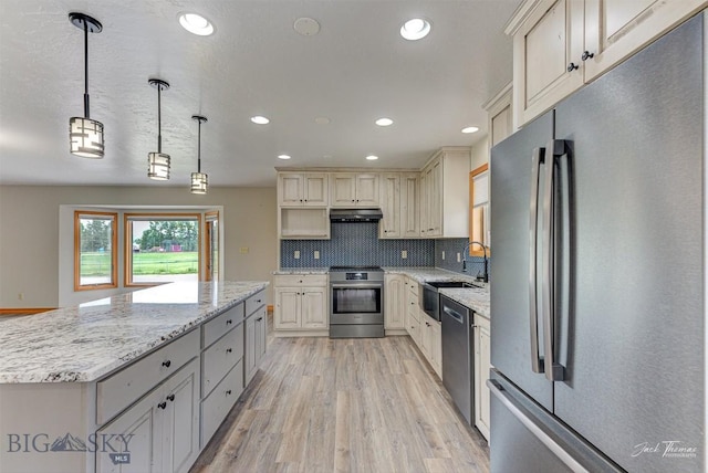 620 Higgins, Deer Lodge, MT 59722 - kitchen with appliances with stainless steel finishes, light wood-type flooring, a center island, recessed lighting, and light stone counters