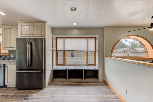 620 Higgins, Deer Lodge, MT 59722 - kitchen with freestanding refrigerator, cream cabinets, tasteful backsplash, light wood-style flooring, and a textured ceiling