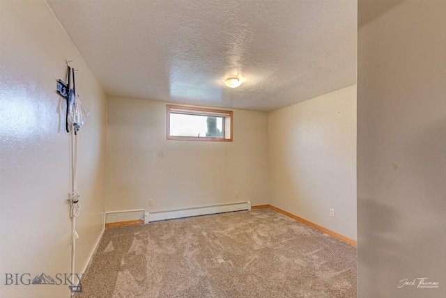 620 Higgins, Deer Lodge, MT 59722 - spare room with baseboard heating, a textured ceiling, and carpet flooring