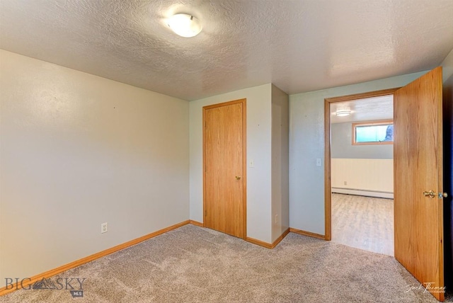 620 Higgins, Deer Lodge, MT 59722 - unfurnished bedroom featuring a baseboard radiator, a textured ceiling, and carpet flooring