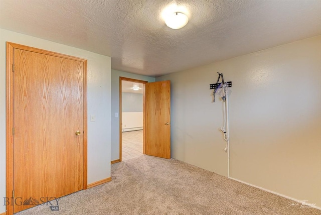 620 Higgins, Deer Lodge, MT 59722 - unfurnished bedroom featuring carpet flooring, a baseboard radiator, and a textured ceiling