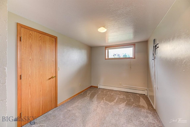 620 Higgins, Deer Lodge, MT 59722 - unfurnished room featuring baseboard heating, carpet, and a textured ceiling