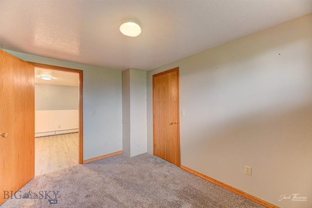620 Higgins, Deer Lodge, MT 59722 - carpeted spare room featuring a baseboard heating unit and baseboards
