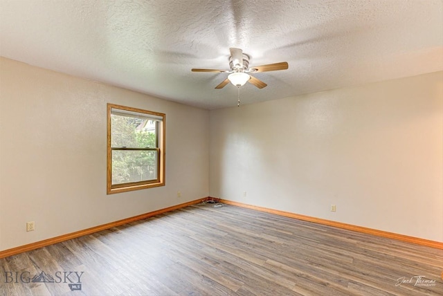 620 Higgins, Deer Lodge, MT 59722 - unfurnished room with wood finished floors, ceiling fan, and a textured ceiling