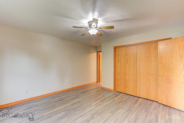 620 Higgins, Deer Lodge, MT 59722 - unfurnished bedroom featuring wood finished floors, a textured ceiling, a closet, and a ceiling fan