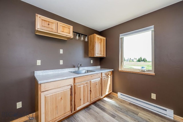241 Aspen Loop Rd, West Yellowstone, MT 59758 - kitchen with baseboard heating, light countertops, light wood finished floors, and light brown cabinetry
