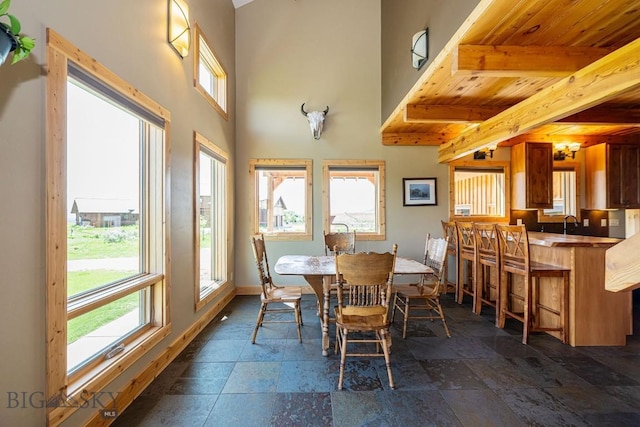 241 Aspen Loop Rd, West Yellowstone, MT 59758 - dining area with stone tile floors and beamed ceiling