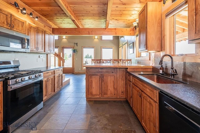 241 Aspen Loop Rd, West Yellowstone, MT 59758 - kitchen featuring appliances with stainless steel finishes, a peninsula, a wood ceiling with exposed beams, brown cabinetry, and dark countertops