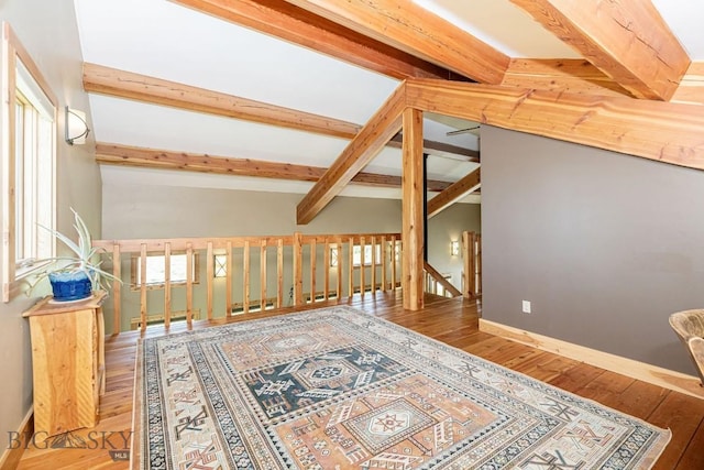 241 Aspen Loop Rd, West Yellowstone, MT 59758 - sitting room with beam ceiling, hardwood / wood-style flooring, and an upstairs landing