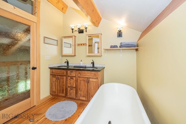 241 Aspen Loop Rd, West Yellowstone, MT 59758 - full bath with a soaking tub, wood finished floors, and double vanity