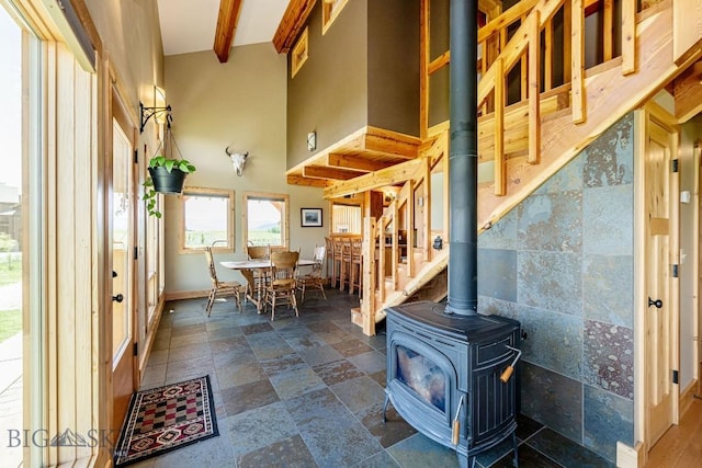 241 Aspen Loop Rd, West Yellowstone, MT 59758 - dining room with a towering ceiling, a wood stove, and dark stone finish floors