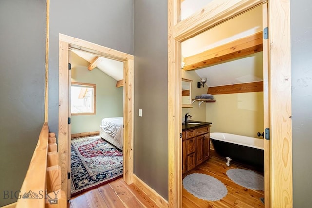 241 Aspen Loop Rd, West Yellowstone, MT 59758 - bathroom featuring a freestanding bath, wood finished floors, ensuite bathroom, and vanity