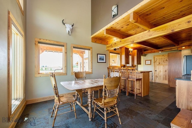 241 Aspen Loop Rd, West Yellowstone, MT 59758 - dining space featuring a wood ceiling with exposed beams and stone tile floors