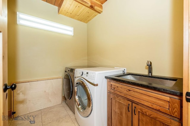 241 Aspen Loop Rd, West Yellowstone, MT 59758 - laundry area with washer and clothes dryer, wood ceiling, light tile patterned floors, and cabinet space