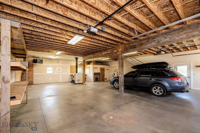 241 Aspen Loop Rd, West Yellowstone, MT 59758 - garage with a garage door opener and a wood stove