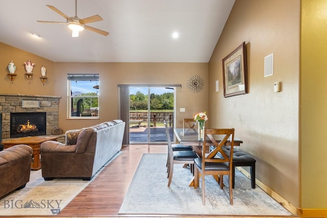 988 Meagher, Bozeman, MT 59718 - living room with plenty of natural light, light wood finished floors, ceiling fan, a stone fireplace, and vaulted ceiling