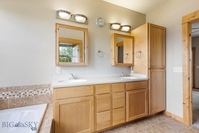988 Meagher, Bozeman, MT 59718 - bathroom featuring a relaxing tiled tub, double vanity, and tile patterned flooring