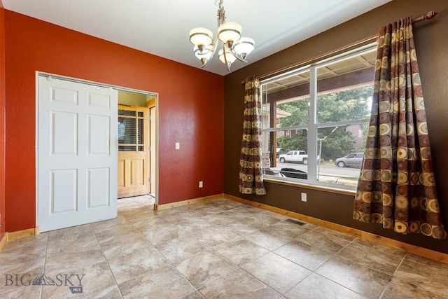 988 Meagher, Bozeman, MT 59718 - spare room featuring a chandelier and baseboards
