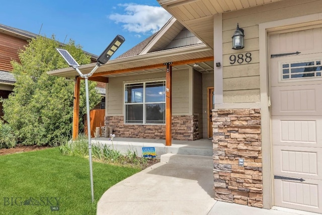 988 Meagher, Bozeman, MT 59718 - view of exterior entry with a porch, stone siding, and a lawn