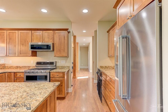 960 Strawberry, Helena, MT 59601 - kitchen featuring stainless steel appliances, light wood finished floors, light stone countertops, recessed lighting, and brown cabinets