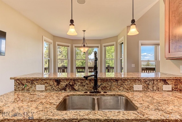 960 Strawberry, Helena, MT 59601 - kitchen featuring light stone countertops, healthy amount of natural light, and pendant lighting