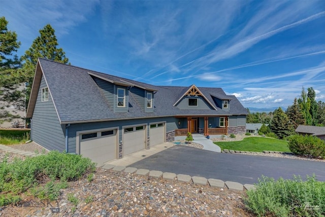 960 Strawberry, Helena, MT 59601 - view of front of house with covered porch, asphalt driveway, roof with shingles, a front lawn, and stone siding