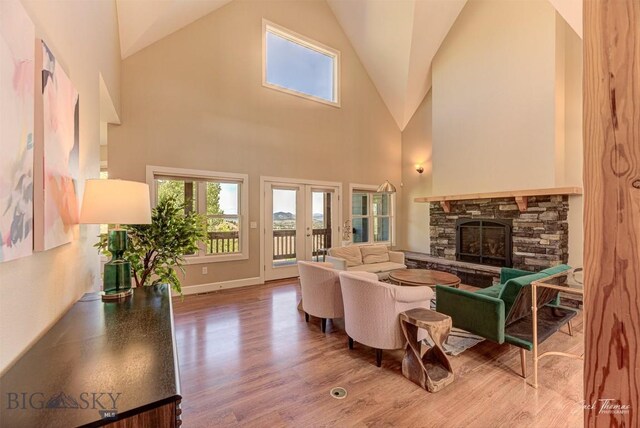 960 Strawberry, Helena, MT 59601 - living room with wood finished floors, a stone fireplace, high vaulted ceiling, and french doors