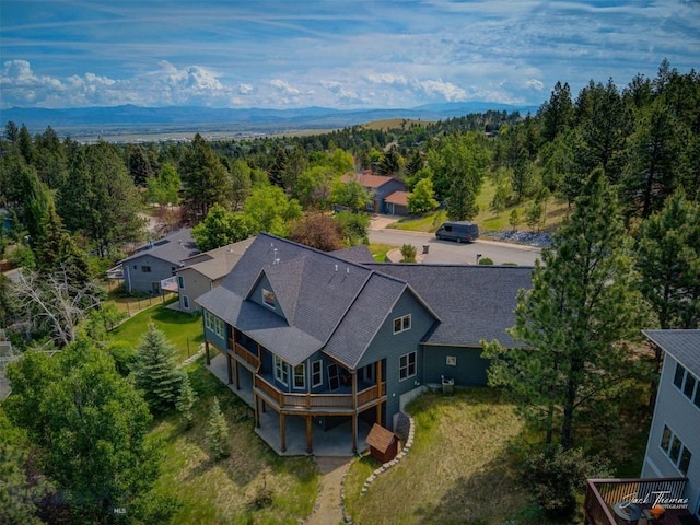 960 Strawberry, Helena, MT 59601 - aerial view of property and surrounding area featuring a heavily wooded area