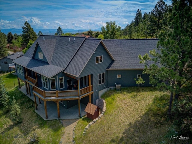 960 Strawberry, Helena, MT 59601 - rear view of property with a patio area, roof with shingles, a yard, a deck, and driveway