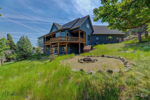 960 Strawberry, Helena, MT 59601 - rear view of property with an outdoor fire pit and a wooden deck