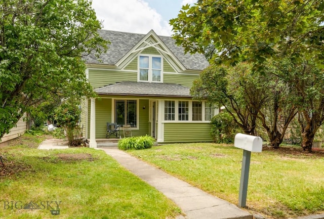 326 S 5th St, Livingston, MT 59047 - victorian home with a porch, a shingled roof, and a front yard