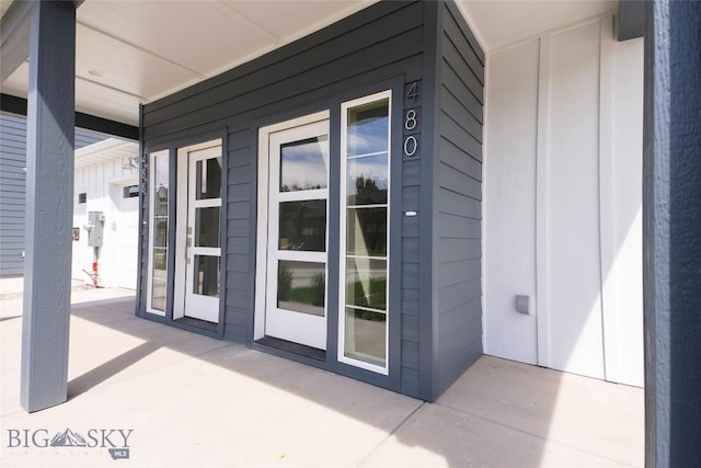 488 Meriwether Ave, Bozeman, MT 59718 - view of exterior entry featuring covered porch and board and batten siding