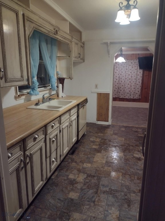 600 C St, Townsend, MT 59644 - kitchen featuring stainless steel dishwasher, light countertops, a chandelier, and dark stone finish flooring