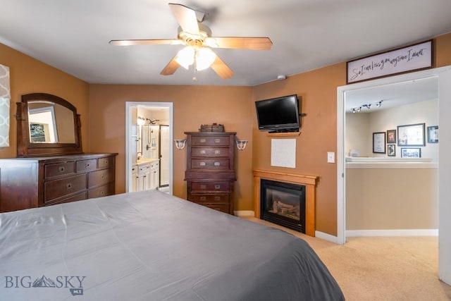 605 E Cameron Brg, Bozeman, MT 59718 - carpeted bedroom featuring a glass covered fireplace, connected bathroom, and ceiling fan