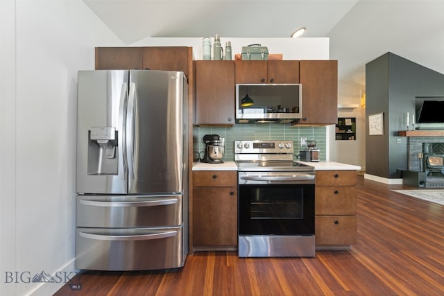 25 W Dooley Ln, Belgrade, MT 59714 - kitchen featuring stainless steel appliances, light countertops, tasteful backsplash, and dark wood-style flooring