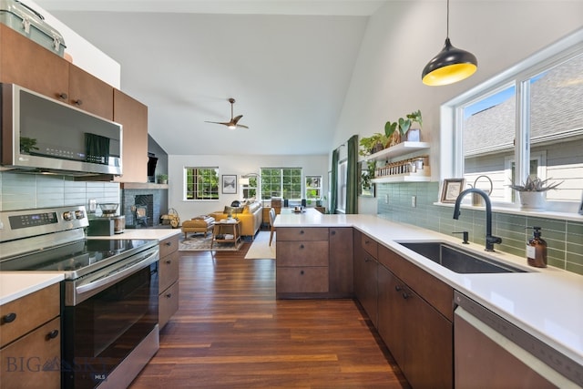 25 W Dooley Ln, Belgrade, MT 59714 - kitchen featuring appliances with stainless steel finishes, ceiling fan, dark wood-type flooring, light countertops, and high vaulted ceiling