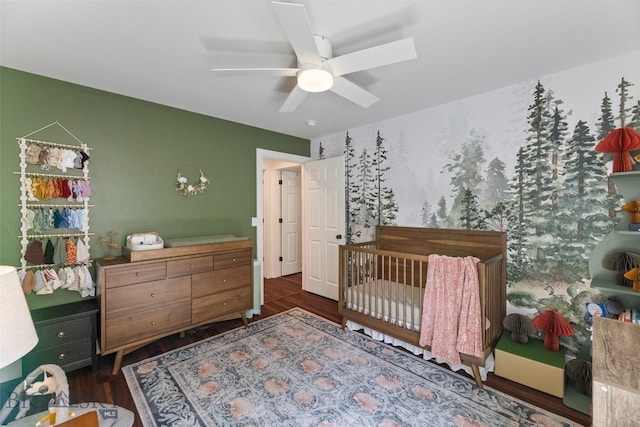 25 W Dooley Ln, Belgrade, MT 59714 - bedroom featuring wood finished floors, a ceiling fan, and a nursery area