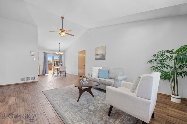 704 Mayfair Dr, Belgrade, MT 59714 - living area featuring ceiling fan, wood finished floors, lofted ceiling, and a chandelier