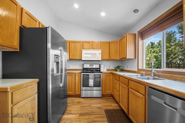 704 Mayfair Dr, Belgrade, MT 59714 - kitchen with appliances with stainless steel finishes, light wood-style floors, lofted ceiling, light countertops, and recessed lighting