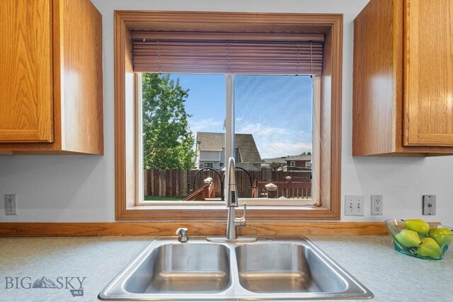 704 Mayfair Dr, Belgrade, MT 59714 - kitchen with light countertops and brown cabinets