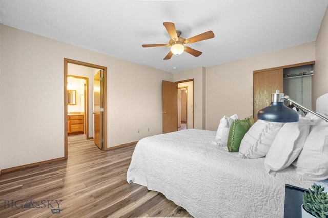 704 Mayfair Dr, Belgrade, MT 59714 - bedroom with wood finished floors, a ceiling fan, and connected bathroom
