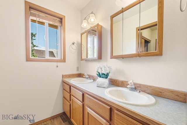 704 Mayfair Dr, Belgrade, MT 59714 - bathroom featuring double vanity and baseboards
