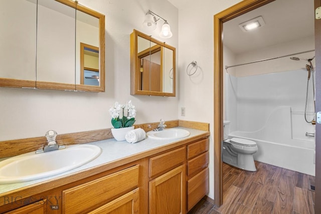 704 Mayfair Dr, Belgrade, MT 59714 - full bath featuring double vanity, bathing tub / shower combination, and wood finished floors