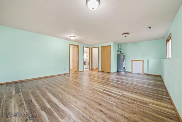704 Mayfair Dr, Belgrade, MT 59714 - spare room featuring gas water heater, washer / dryer, and light wood-style floors