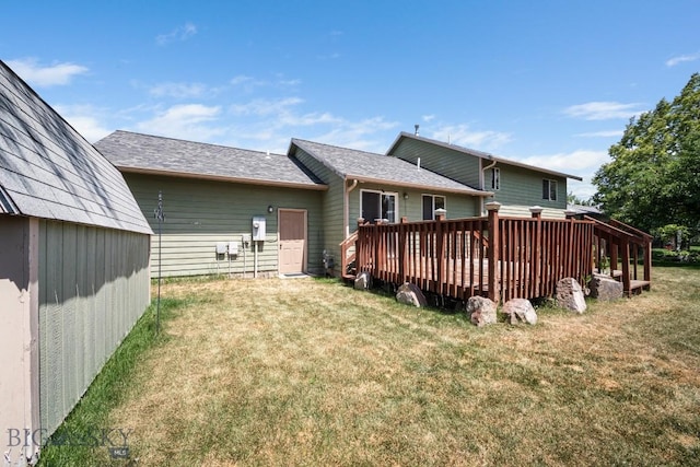 704 Mayfair Dr, Belgrade, MT 59714 - back of property featuring a lawn, a deck, a storage shed, and a shingled roof