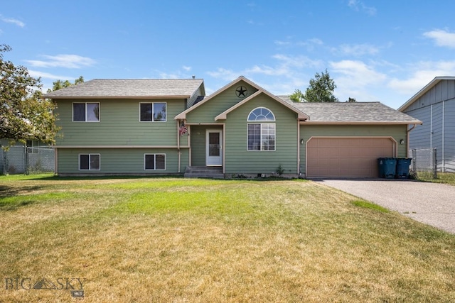 704 Mayfair Dr, Belgrade, MT 59714 - tri-level home featuring an attached garage and asphalt driveway
